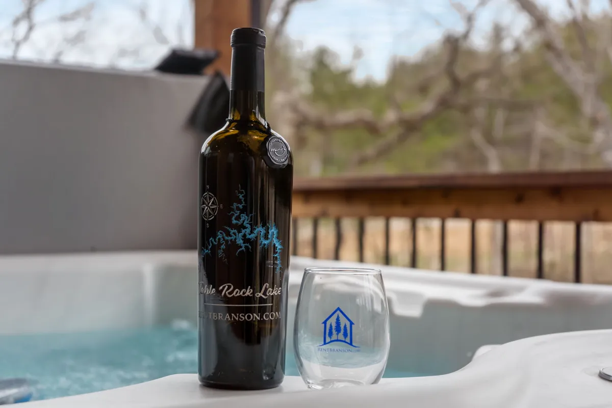 This interior image features a wine bottle, wine glass, and a hot tub, creating a tranquil and inviting scene. The focus is on relaxation and socializing, suggesting a space where friends can unwind together after a busy day.